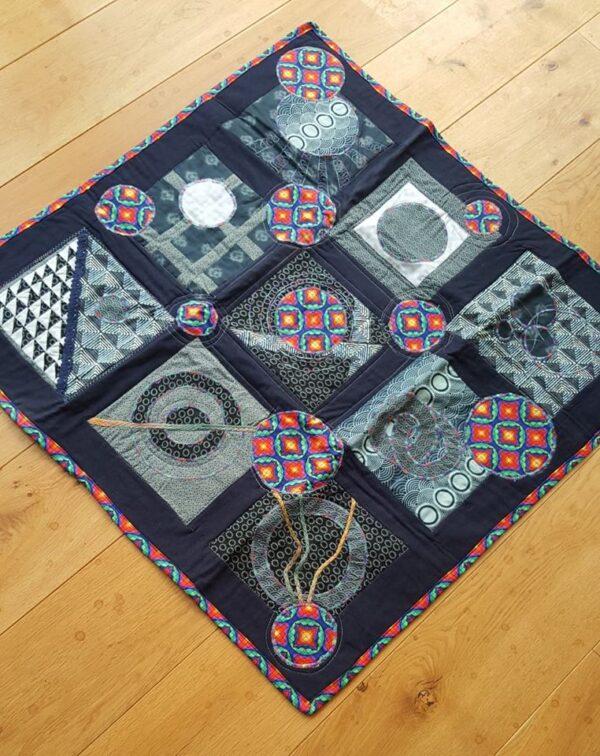 black quilt with a variety of circle designs