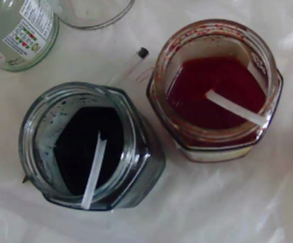 Indigo and Magenta Dye solutions in jam jars with teaspoons