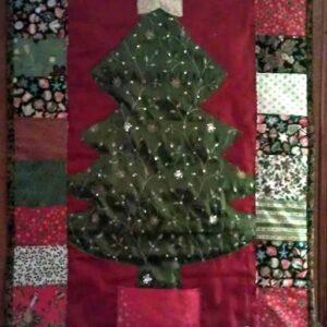 Advent Calendar made from green sari fabric tree, applique gold star and various christmas fabrics creating the pockets